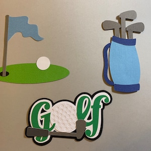 May include: A green golf course with a blue flag, a white golf ball, and a golf bag with gray golf clubs. The word "Golf" is written in green letters with a white golf ball.