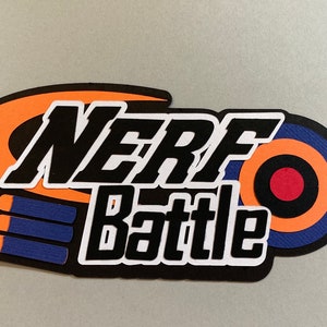 May include: A colorful paper cutout featuring the words "NERF Battle" in bold black letters with a white outline. The design includes orange, blue, and red elements, including a target and dart-like shapes, suggesting a toy gun theme.