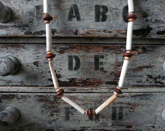 Necklace made from recycled clay pipe fragments collected from the River Thames with brown and natural wooden beads