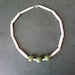 24" clay pie necklace with three green ceramic beads at front centre