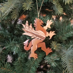 GRIFFIN CHRISTMAS ORNAMENT A legendary mythical creature with body of a lion and and head, and wings of a bird. image 1