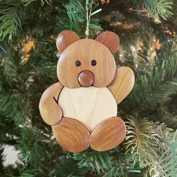 TEDDY BEAR Christmas ORNAMENT.  This cuddly teddy bear can hold it's own amid the most bright holiday tree.