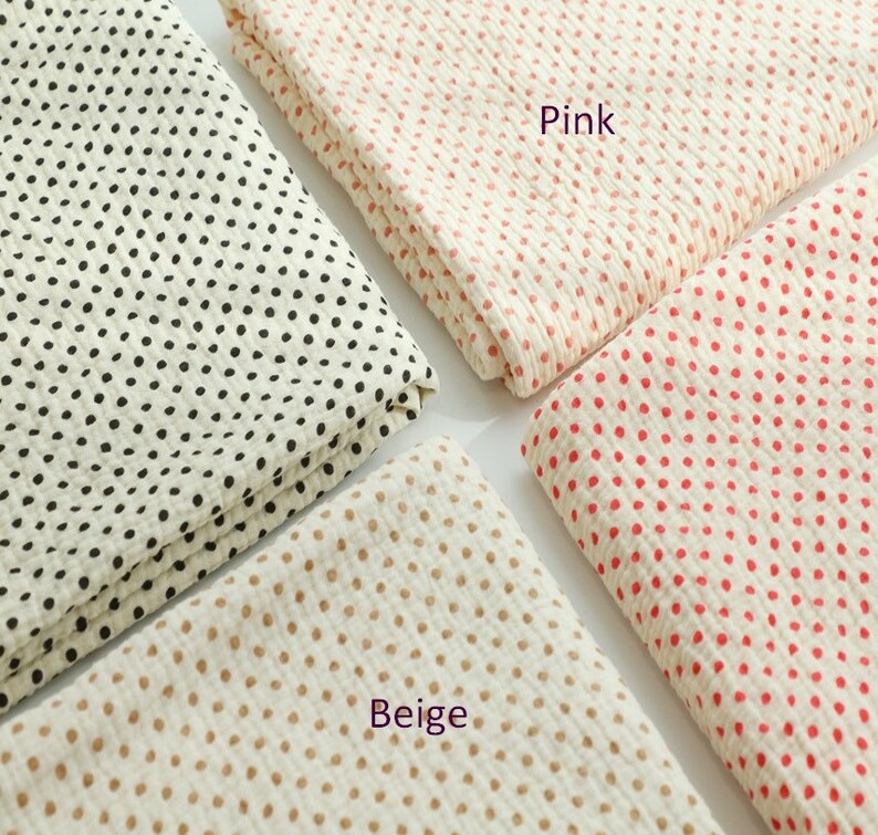 May include: Four fabric swatches with white backgrounds and different colored polka dots. The swatches are labeled "Pink", "Beige", and "Black".
