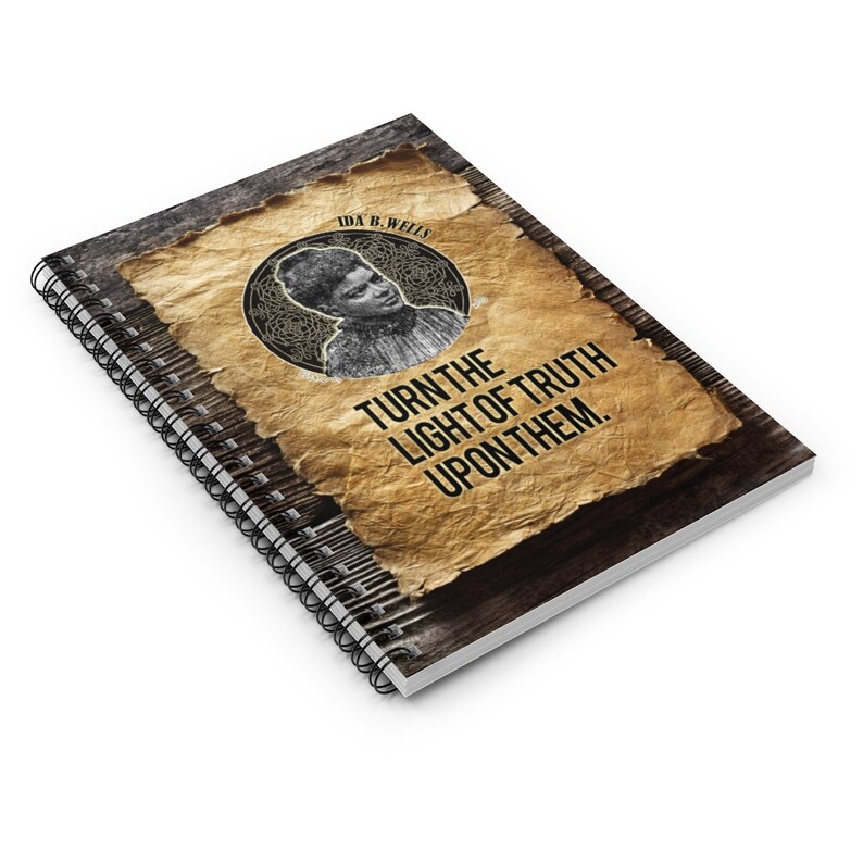 May include: A spiral bound notebook with a vintage-style design featuring a portrait of Ida B. Wells and the quote "Turn the light of truth upon them."