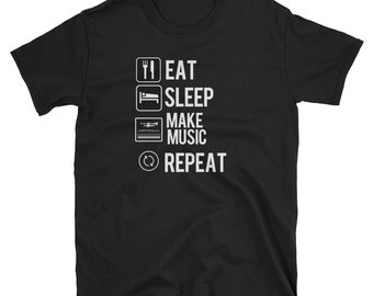 May include: Black t-shirt with white text that reads "Eat, Sleep, Make Music, Repeat".