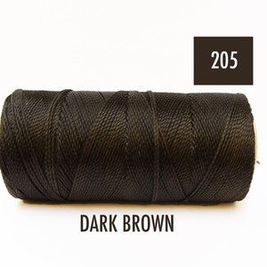 May include: A spool of dark brown waxed thread, labeled "205 DARK BROWN".