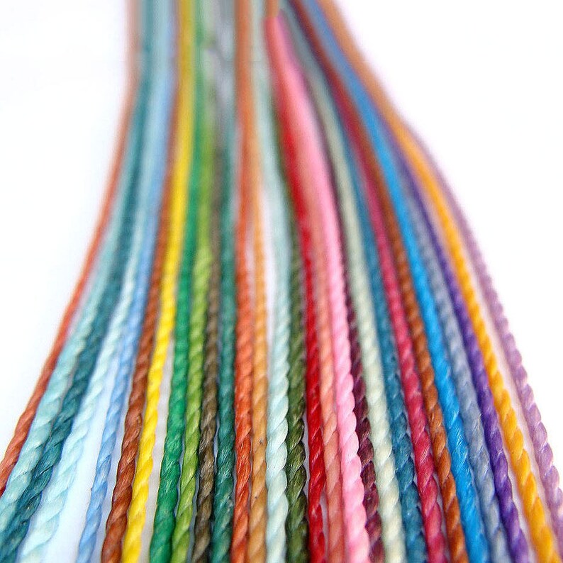 May include: A collection of colorful twisted cords of yarn in various shades of blue, green, yellow, red, pink, and purple.