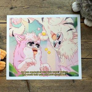 Puede incluir: Una impresión que presenta dos personajes Furby estilizados en un estilo anime pastel. Uno es rosa, el otro blanco, con el texto: "Do you remember who you were? Before the world told you who you should be?"