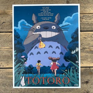 Puede incluir: Un póster de la película de animación "Mi vecino Totoro". La obra de arte representa al gran personaje de Totoro sosteniendo un pequeño objeto, con dos niños corriendo hacia él. El texto incluye el título de la película y una cita. El fondo es una escena nocturna.