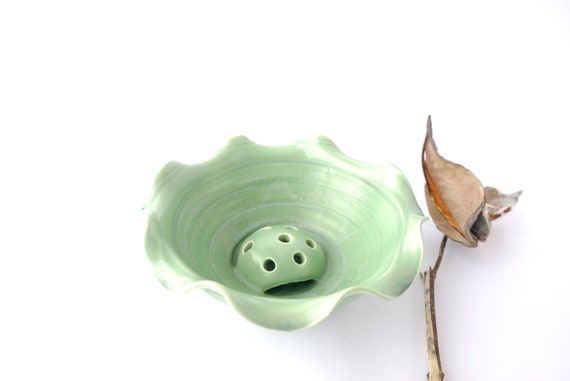 A handthrown and unique ceramic flower frog to dress up your table