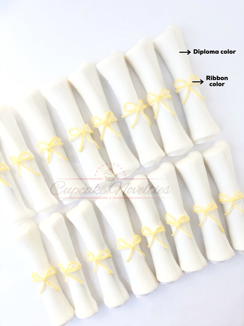 May include: White chocolate graduation diplomas with yellow ribbon bows.  Diploma color and ribbon color are indicated by arrows.