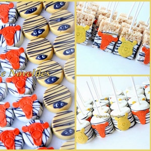 May include: A collection of Winnie the Pooh themed party favors, including chocolate-covered Oreos, Rice Krispie treats, and lollipops. The treats are decorated with Winnie the Pooh and zebra print designs.