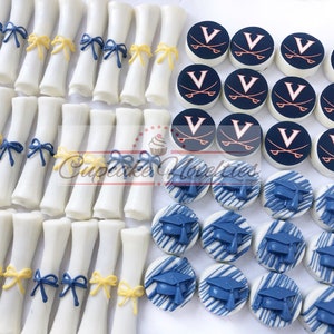 May include: Assortment of graduation-themed chocolate treats. White chocolate diplomas with blue and yellow ribbon accents. White chocolate round cookies with blue and white graduation caps and white chocolate round cookies with a navy blue background and a white "V" with crossed swords in orange.