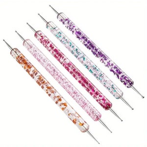 May include: Set of six nail art dotting tools with clear handles filled with colorful glitter. The tools have a variety of sizes and are perfect for creating intricate nail designs.