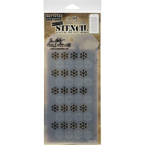 May include: A clear plastic stencil with a snowflake design. The stencil is packaged in a clear plastic bag with a white label that says "Jim Holtz Collection Shifter Stencil" and "Use with inks, paint, pastes, and more".