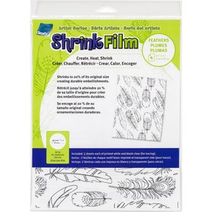 May include: A package of Grafix Shrink Film with a feather design. The package includes 4 sheets, each measuring 8.5 x 11 inches. The film shrinks to 20% of its original size. The package has text in English, French, and Spanish.
