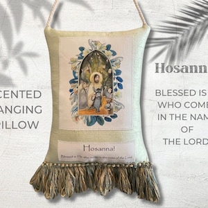 May include: A rectangular, scented hanging pillow with a religious illustration. The pillow is light green with a decorative fringe at the bottom. The image features text that reads "Hosanna!" and "Blessed is He who comes in the name of the Lord!"