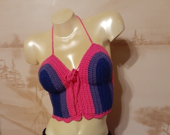May include: A pink, purple, and blue crocheted halter top with a scalloped hem.
