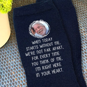 May include: Black socks with a white circle containing a photo of a man and the text "WHEN TODAY STARTS WITHOUT ME, WE'RE NOT FAR APART, FOR EVERY TIME YOU THINK OF ME, I'M RIGHT HERE IN YOUR HEART."
