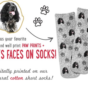 May include: A pair of gray cotton socks with a black and white dog face and paw print pattern. The socks are digitally printed with a custom pet photo.