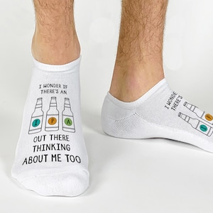 May include: White ankle socks with a humorous graphic of beer bottles and the text "I wonder if there's an IPA out there thinking about me too."
