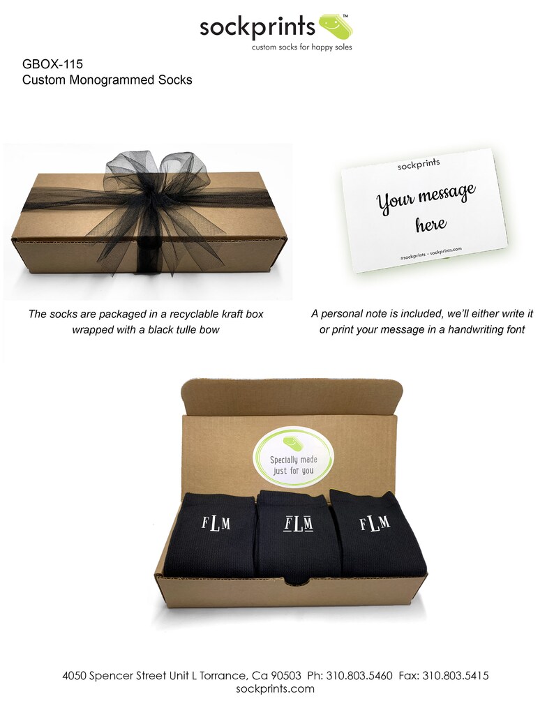 May include: A brown cardboard box with a black tulle bow, containing three pairs of black socks with white embroidered initials "FLM". The box is open and the socks are visible. The box has a sticker that says "Specially made just for you".