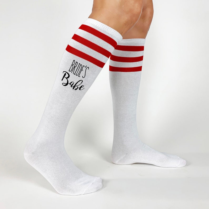 Brides babe or bride custom printed on the sides of each pair of cotton striped knee high socks make a great gift for your wedding party. These unique socks are one of a kind and digitally printed to make your day special.