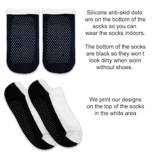 May include: Two pairs of black and white socks with silicone anti-skid dots on the bottom. The socks are designed to be worn indoors without shoes. The text on the image reads: "Silicone anti-skid dots are on the bottom of the socks so you can wear the socks indoors. The bottom of the socks are black so they won't look dirty when worn without shoes. We print our designs on the top of the socks in the white area."