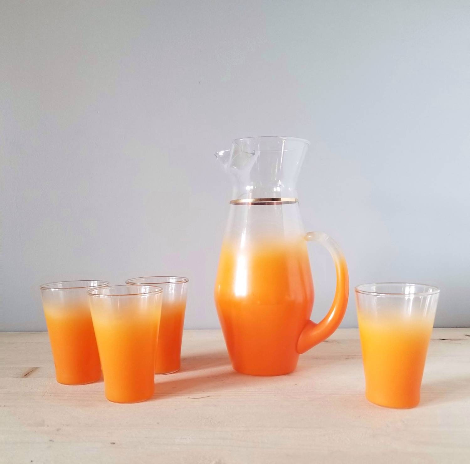 Vintage blendo pitcher with four glasses orange juice glasses