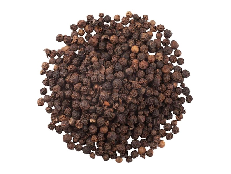 May include: A pile of whole black peppercorns, dark brown in color, against a white background. The peppercorns are small, round, and have a textured surface. This image is suitable for culinary and spice-related themes.