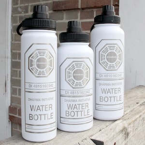 May include: Three white water bottles with black lids and a silver Dharma Initiative logo. Each bottle has the text "DI 4815162342" and "DHARMA INITIATIVE WATER BOTTLE".