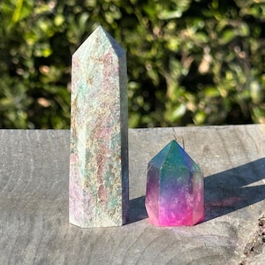 May include: A white ceramic mug with a black handle and the text "But First, Coffee" in a black, bold font. The mug is on a white surface.