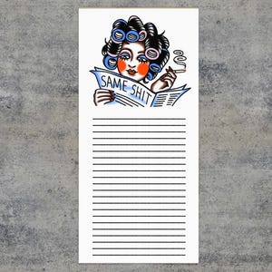 May include: A white notepad with a vintage tattoo-style illustration of a woman with curlers reading a newspaper. The newspaper reads "SAME SHIT". The woman is smoking a cigarette. The notepad has horizontal lines.