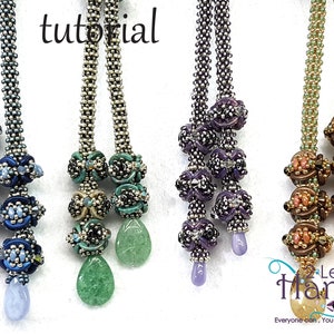May include: Four pairs of beaded necklaces with different coloured beads and pendants. The necklaces are made with silver-coloured seed beads and feature a variety of colours, including blue, green, purple, and brown. The word "tutorial" is written in white letters on a black background at the top of the image. The text "Left Hands" is written in white letters on a black background at the bottom of the image. The text "Everyone can, You can bead too..." is written in white letters on a black background below the text "Left Hands".