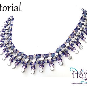 May include: A beaded necklace with a silver and purple color scheme. The necklace features a cascading design with teardrop-shaped beads. The necklace is labeled "2 Left Hands" and "Everyone can, You can bead too..."