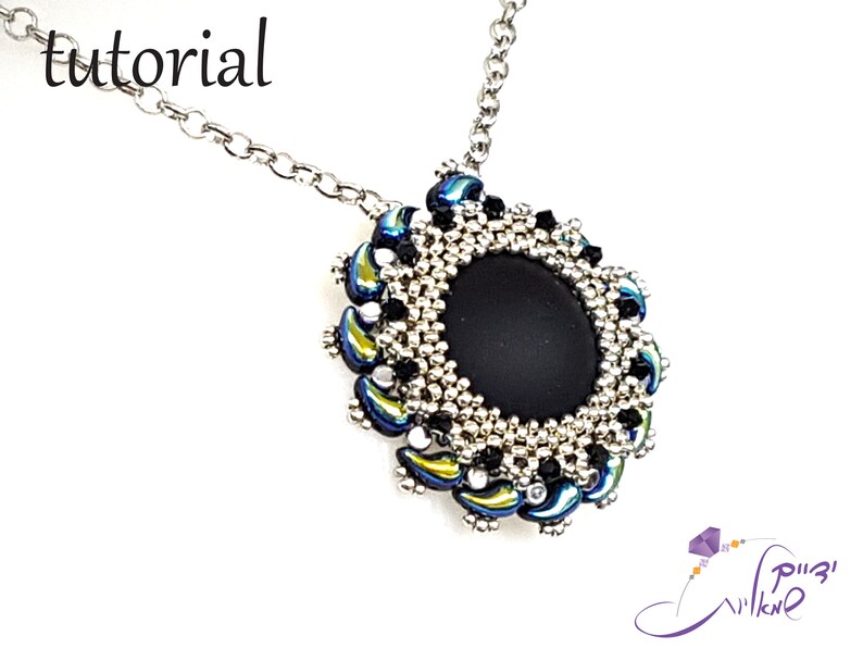 May include: A silver chain necklace with a black and silver beaded pendant. The pendant features a round black stone surrounded by silver and iridescent blue beads.