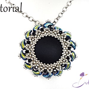May include: A silver chain necklace with a black and silver beaded pendant. The pendant features a circular design with a black center and a border of silver and iridescent blue and green beads.