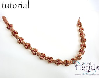May include: A close-up of a red and gold beaded necklace. The necklace is made with small seed beads and larger, faceted beads. The necklace is on a white background. The text "2 Left Hands" is visible in the lower right corner of the image.