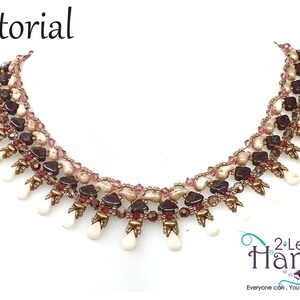May include: A multi-strand beaded necklace with a cascading fringe of white teardrop beads. The necklace is made with brown, pink, and white beads, and gold accents. The necklace is labeled "2 Left Hands" with the tagline "Everyone can, You can bead too..."