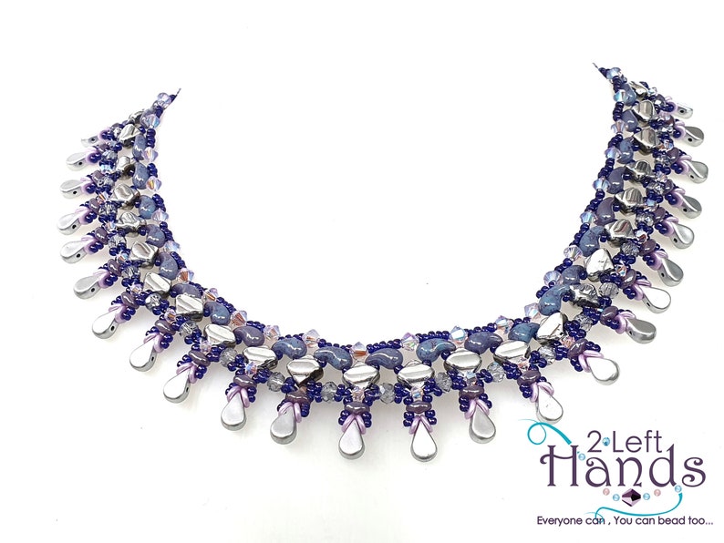 May include: A silver and purple beaded necklace with a teardrop design. The necklace is made with various sizes and shapes of beads, including silver, purple, and blue.