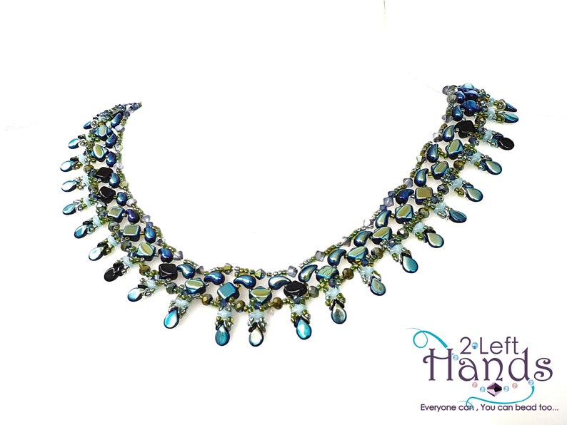 May include: A multi-strand necklace with teardrop-shaped beads in shades of blue, green, and black. The necklace is made with iridescent glass beads and has a cascading design.