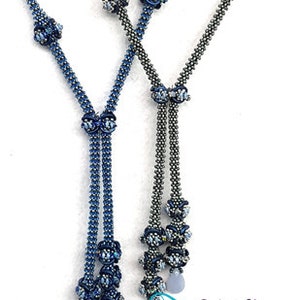 May include: Two beaded necklaces with blue and silver beads, featuring a floral design. The necklaces are tied together at the bottom with a knot. The image includes the text "2 Left Hands" and "Everyone can, You can bead too."