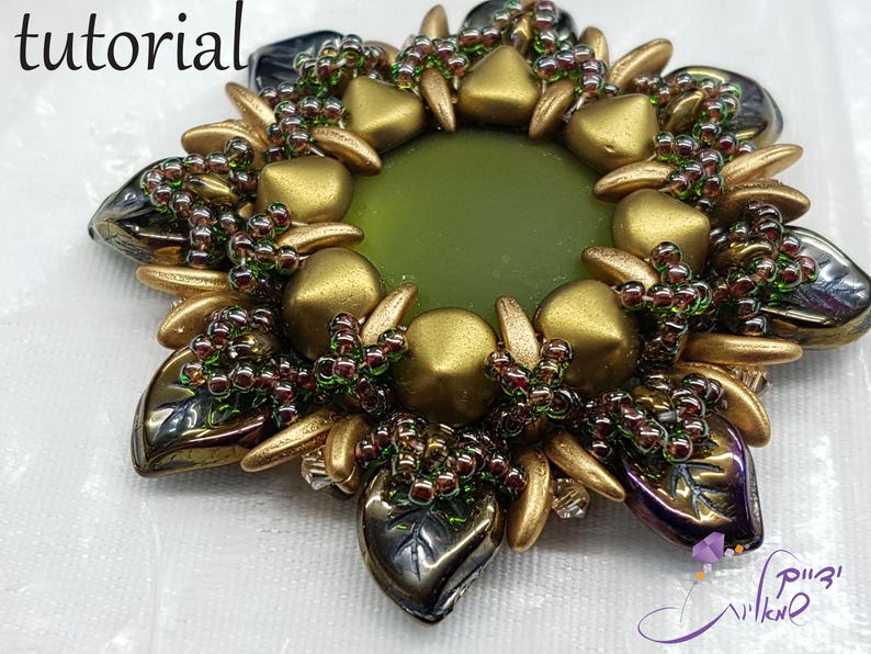 May include: A gold and green beaded flower brooch with a green center. The brooch is made with small beads and has a starburst shape.