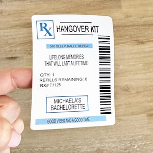 May include: A white rectangular sticker with a blue Rx symbol and the words "Hangover Kit". The sticker includes text: "Sip, Sleep, Rally, Repeat", "Lifelong Memories That Will Last a Lifetime", and "Michaela's Bachelorette".