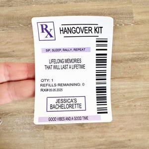 May include: A white sticker with the text "HANG OVER KIT" in black. The sticker includes the phrases "SIP, SLEEP, RALLY, REPEAT", "LIFELONG MEMORIES THAT WILL LAST A LIFETIME", and "JESSICA'S BACHELORETTE". A barcode is on the right side.
