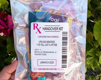May include: A clear, iridescent zip-lock bag containing a "Hangover Kit" with various items. The label reads "Hangover Kit" with the text "Sip, Sleep, Rally, Repeat." The label also includes the text "Lifelong Memories That Will Last a Lifetime" and "Jamaica 2025."