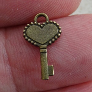 French Bronze Key Charm Pendant Brass Skeleton Key to open a heart. ( B 17 )