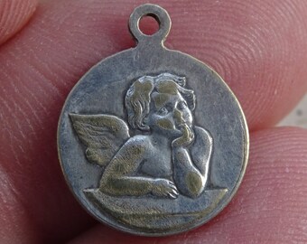 Religious antique silvered catholic medal pendant charm medallion of a cherub guardian angel and Holy Virgin Mary of Banneux. ( 21 )