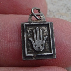 French silvered medal charm medallion pendant of a hand with face.  ( E 3 )