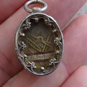 Religious antique French silver ( MARKED ) French theca medal shrine with relic reliquary of John Gabriel Perboyre. ( 15 G )